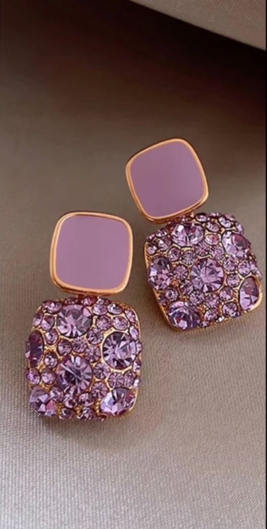 Detailed view of the Lakshmira Square Crystal Rhinestone Earrings in purple, featuring gold plating and stunning square crystals