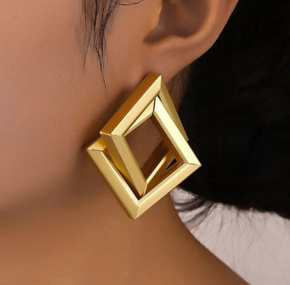 Lakshmira Gold Square Stud Earrings worn on a model, showing their stylish and modern appeal.