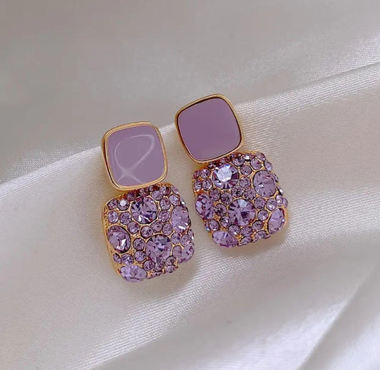 Elegant Lakshmira Square Crystal Rhinestone Earrings in purple displayed on a white background, highlighting the gold-plated finish and square rhinestones.