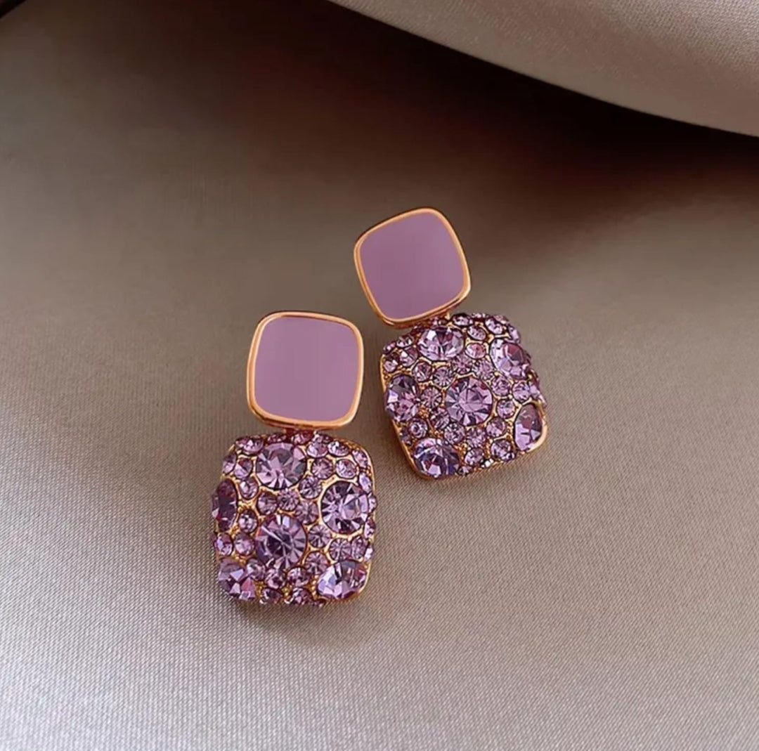 Lakshmira Square Crystal Rhinestone Earrings in purple styled with a casual outfit, adding a pop of color and sparkle.