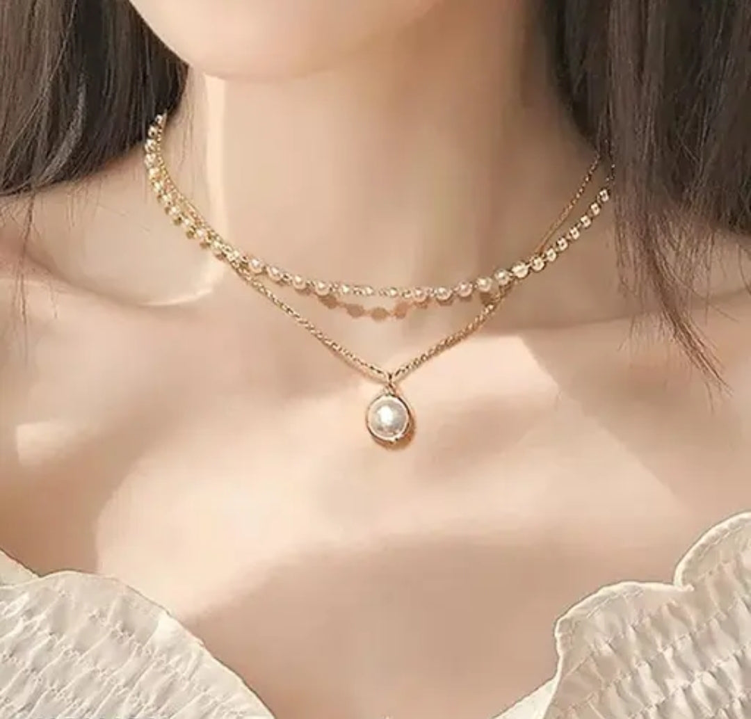 Lakshmira Double Layer Pearl Necklace worn on a model, emphasizing its graceful layered style and pearl embellishments.