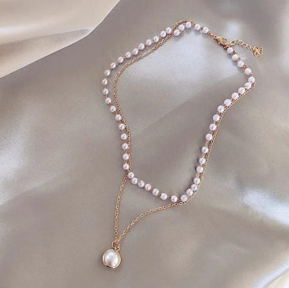 Detailed view of the Lakshmira Double Layer Pearl Necklace, featuring the gold-plated chains and lustrous pearls